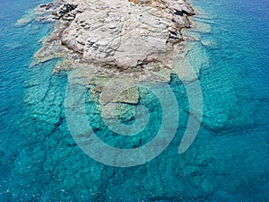 Azure water texture, transparent sea surface with a rocky bottom. Aerial view, Naxos,natural blue background,