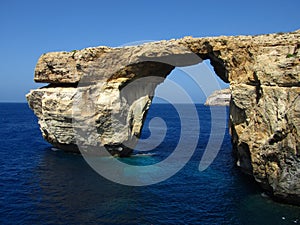 Azure Window surrounded by the sea under the sunlight and a blue sky in Malta