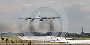 B52 bomber over runway photo