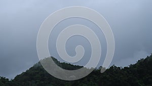 B-roll TimeLapse of Foggy mist clouds moved on green mountain range or rainforest hill top