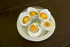 b salted duck egg telur asinserved in white plate isolated on wood background
