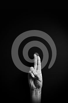 B&W image of hand demonstrating ASL sign language letter U with empty copy space