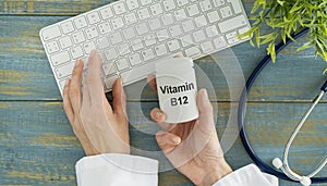 B12 vitamin supplement in white jar in doctor hands in gloves. Medical prescription concept