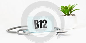 B12 word on notebook,stethoscope and green plant