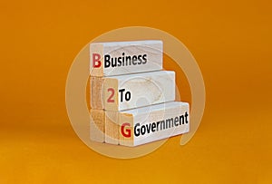 B2G business to government symbol. Concept words `B2G - business to government` on wooden blocks on a beautiful orange backgroun