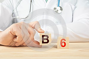 B6 alphabet on wood cube. doctor recommends taking vitamin b6. doctor talks about the benefits of vitamin b6. B6 Vitamin - Health