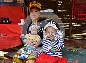 Thai long-neck Kayan woman giraffe woman with two children.
