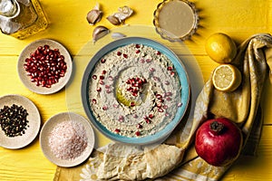 Baba ganoush or mutabal, Middle Eastern eggplant dip sauce garnished with pomegranate seeds, with various ingredients