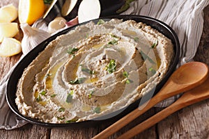 Baba ghanoush closeup with ingredients on the table. horizontal