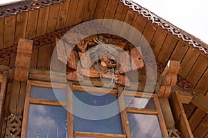 Baba Yaga with a broom near a wooden hut