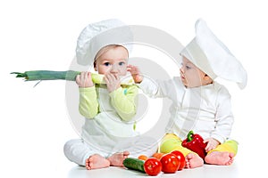 Babies boy and girl with vegetables