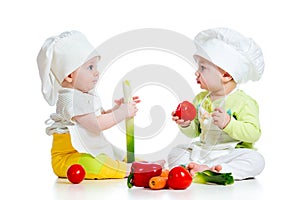 Babies boy and girl with vegetables