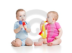 Babies girl and boy play musical toys