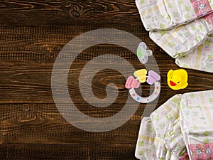 Babies items on wooden background