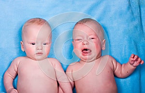 Babies - one looking, one crying