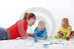 Babies painting with mother