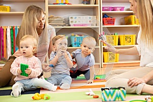 Babies is playing in nursery. Children in the daycare center. Fun in the children`s playroom