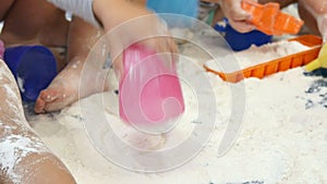 Babies Playing with White Flour in Kindergarten Childcare