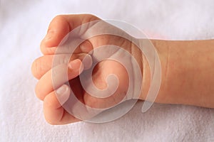 Babies right hand with curled fingers