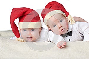 Babies with santa hats on bright background