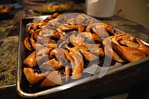 Babka twist danish buns with chocolate on a tray abstract close