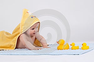 Baby with 3 yellow ducks