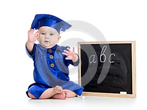 Baby in academician clothes and chalkboard