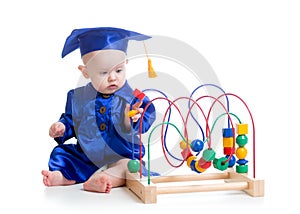 Baby in academician clothes with educational toy