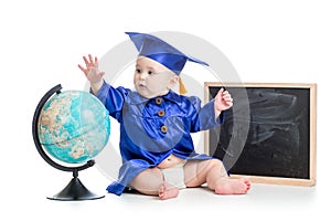 Baby in academician clothes with globe at chalkboard