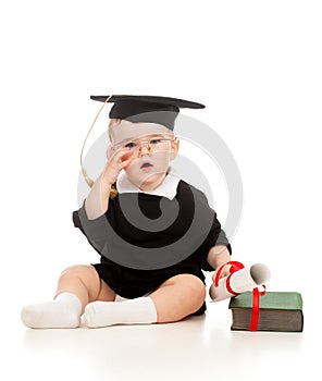 Baby in academician clothes with roll and book