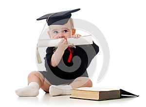 Baby in academician clothes with roll and book