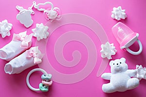 Baby accessories and toys on pink background. Top view. child flat lay with white toys