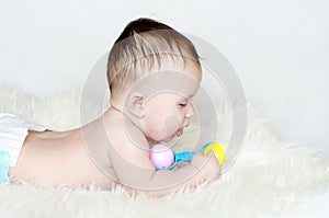 Baby age of 4 months with rattle