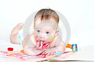 Baby age of 4 months draws finger-type paints