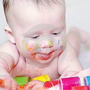 Baby age of 4 months with finger-type paints