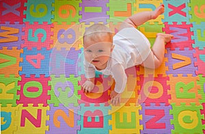 Baby on alphabet mat photo