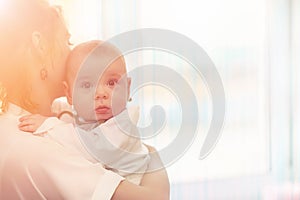 Baby in the arms of the girl. Mom holds her child in her arms. H