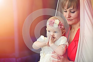 Baby in the arms of the girl. Mom holds her child in her arms. H