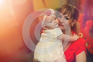 Baby in the arms of the girl. Mom holds her child in her arms. H