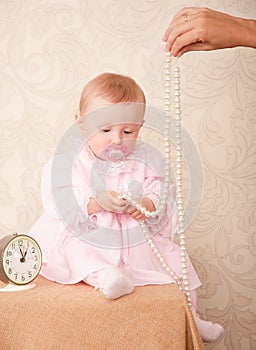 The baby around the clock on a background