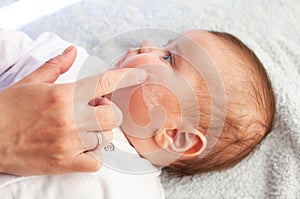 Baby with atopic dermatitis getting cream put. Care and Prevention Of Eczema photo
