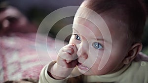 Baby Attentively watch TV. Darck backgroung, Slow motion