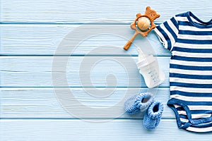 Baby background - blue color. Clothes and accessories for newborn boy on blue wooden table top-down frame copy space
