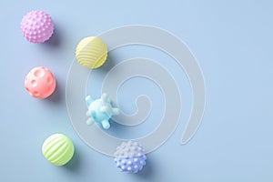 Baby balls toys for bath on blue background. Flat lay, top view. Minimal style