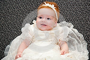 Baby in baptismal clothing