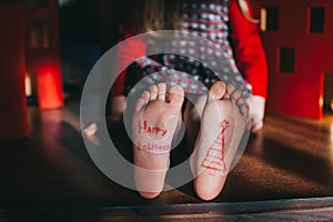 Baby bare feet on the wooden floor.