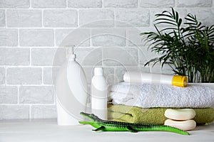 Baby bath amenities, towel, green rubber crocodile and shampoo bottles. The concept of child care