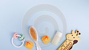 Baby bath products on blue background with copy space. flat lay soap bar, yellow rubber duck and liquid soap, toy
