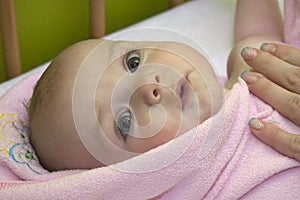 Baby after bath in towel