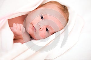 Baby after bath in towel